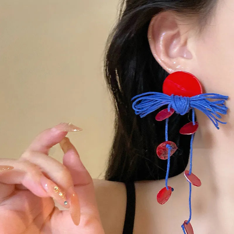 Geometric cloth hoop earrings with blue resin flower detail and manual processing