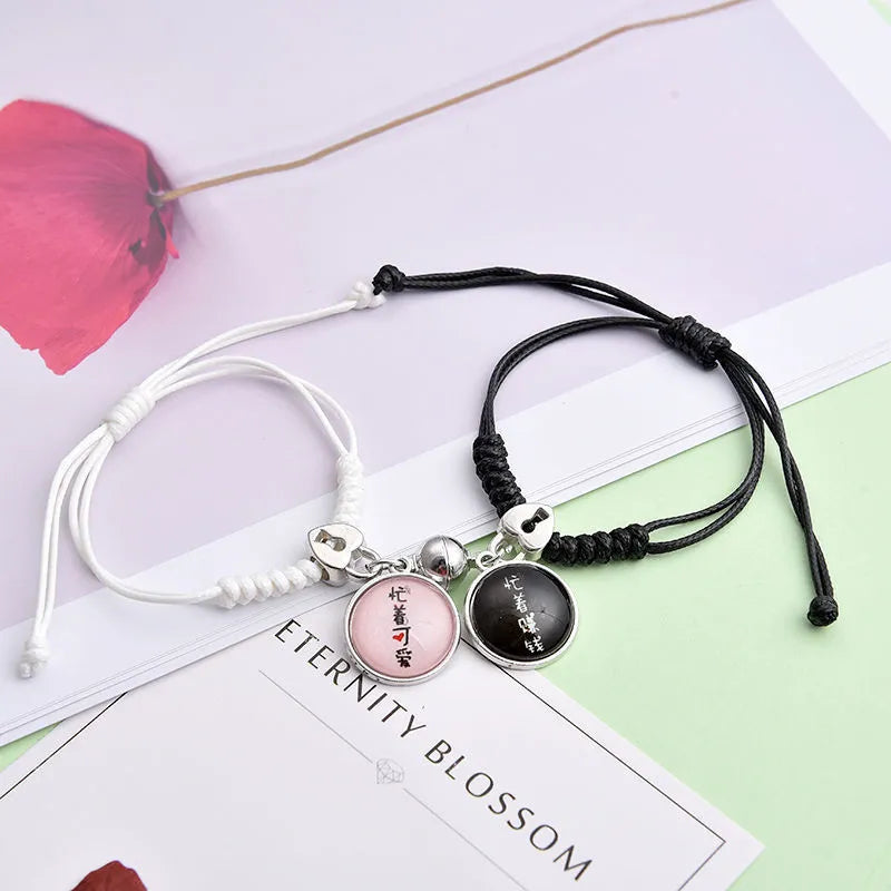 Pair of alloy suction bracelets with engraved symbol choices including crown, love lock, and clover.