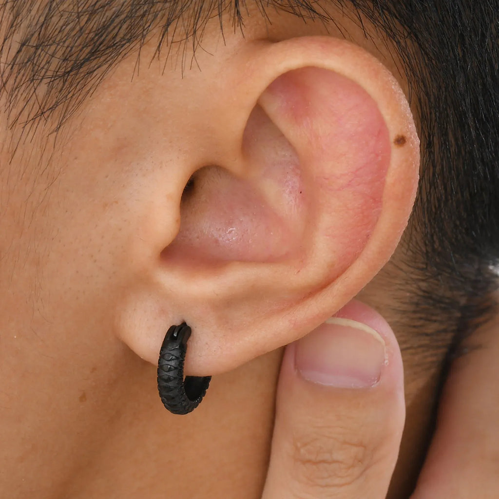 A pair of stainless steel earrings with a snake pattern design in black or gold.