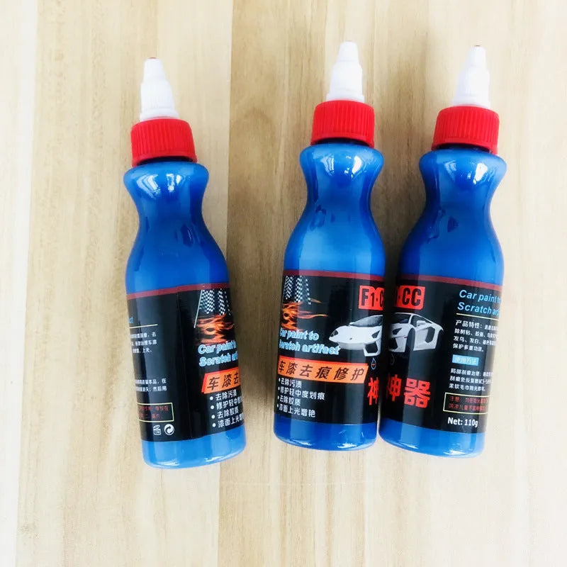 Small blue container of scratch repair agent with integrated wiping tool for automotive paint