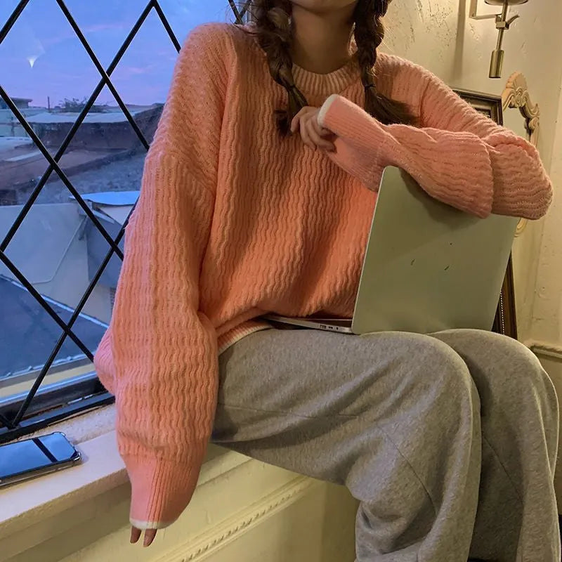 Women's loose blue retro pullover sweater with regular sleeves on a hanger
