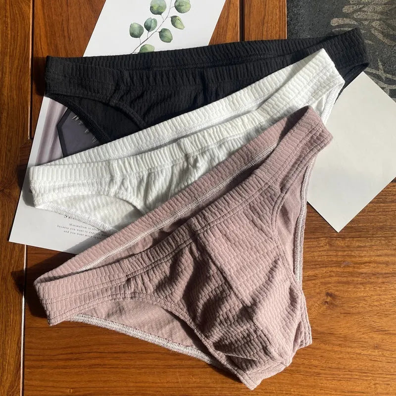 Men's solid colour cotton briefs with a mid waist and triangle design.