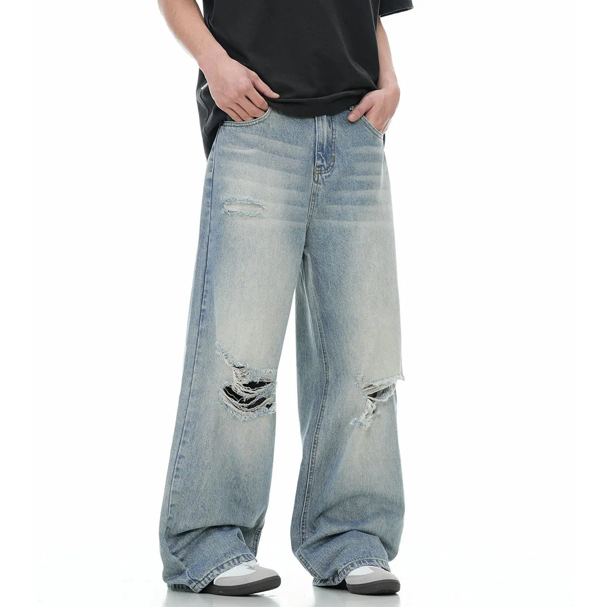 Men's blue straight-leg jeans with ripped detailing on the legs and a zipper fly closure.
