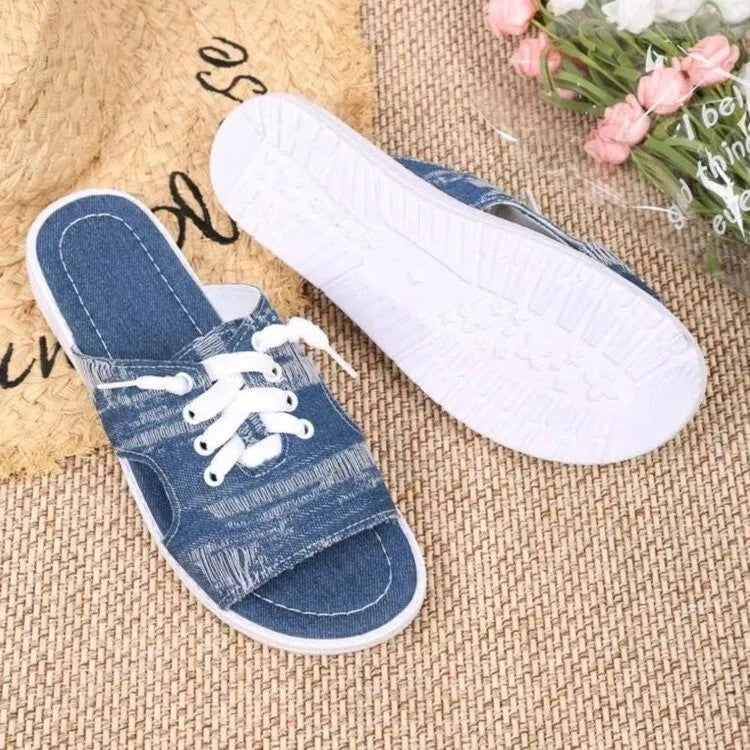 Blue women's flat Roman-style canvas slippers with cloth upper and rubber sole.
