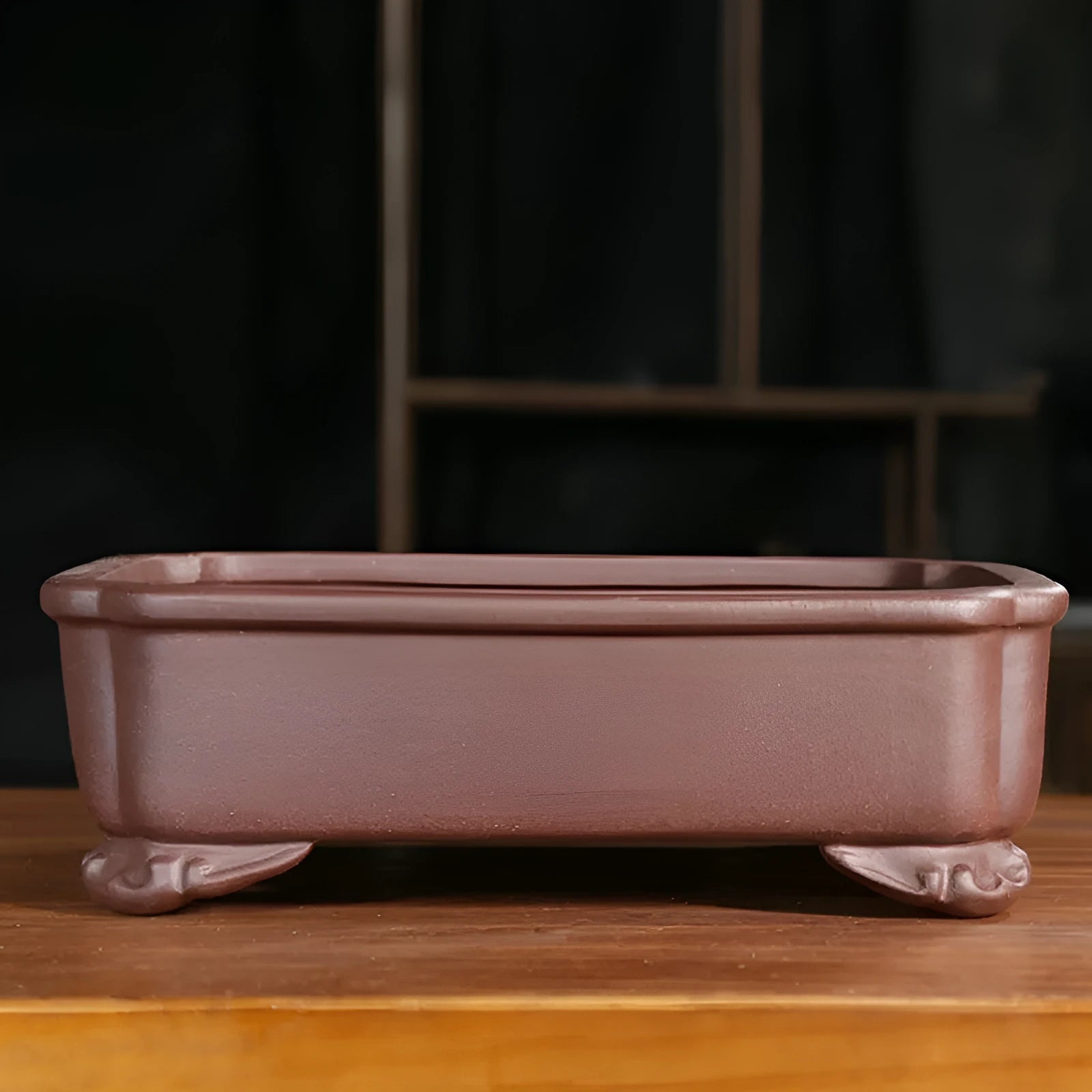 Antique-style rectangular purple sand planter with cut corners on a floor.