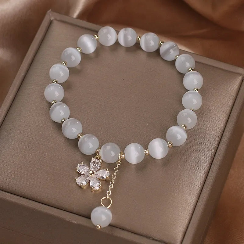 Women's white cat's eye crystal bracelet with flower tassel and morganite safety buckle pendant