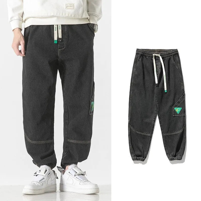 Men's loose-fit tapered cotton trousers in black colour showing mid-waist design and tapered leg cut