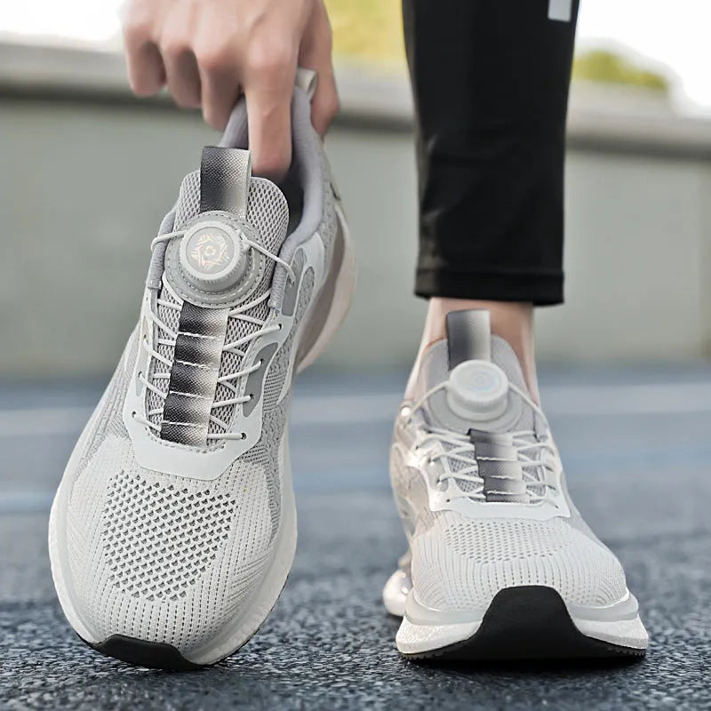 White rotating buckle low-top running shoes with breathable fly-knit mesh upper on a grey background.