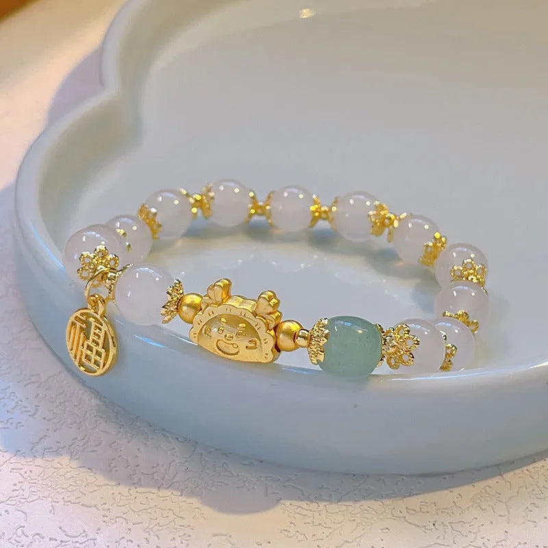 Niche Girlfriends Ice Crack Floral glazed bracelet with red, pink, and white glass beads and a zodiac charm.