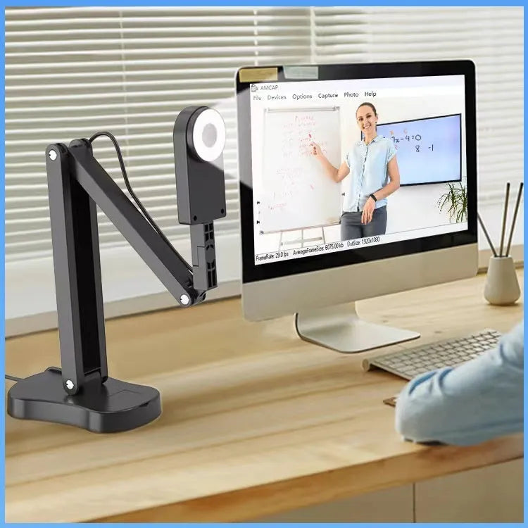 USB webcam with microphone for computer video calls, showing auto focus lens and cable connection
