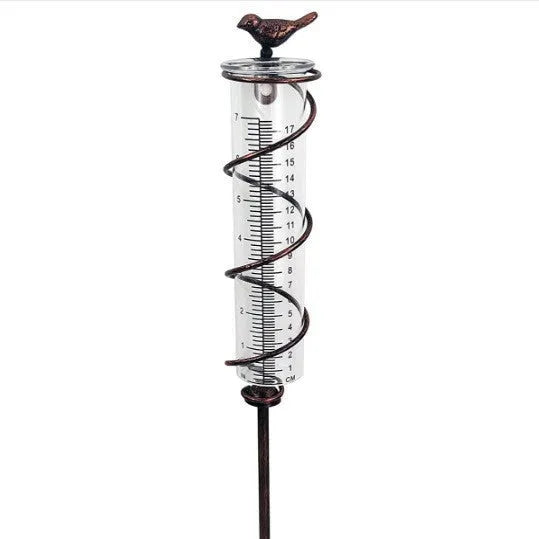 Cast iron bird rain gauge with glass measurement tube showing 1-20 scale for garden rainfall monitoring