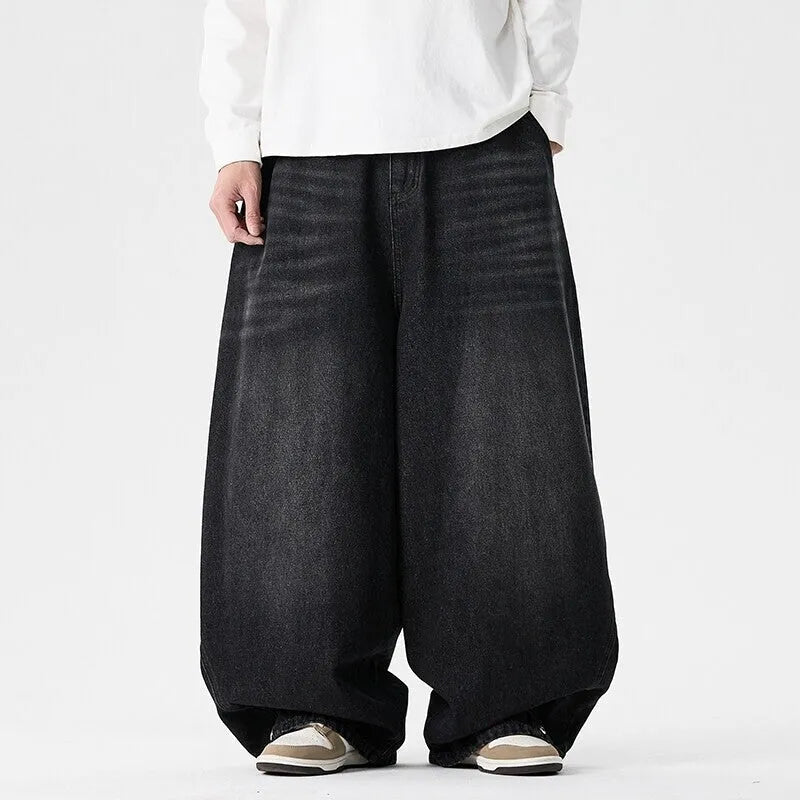 Men's plus-size baggy jeans in light blue denim with straight legs and low waist.