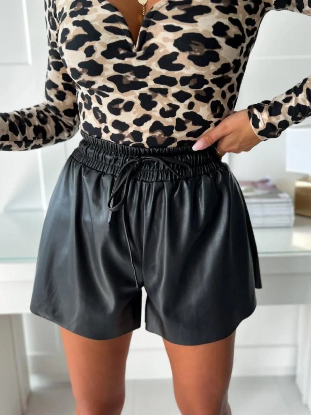 Women's black PU leather shorts with drawstring lace-up waist and wide-leg straight-leg styling