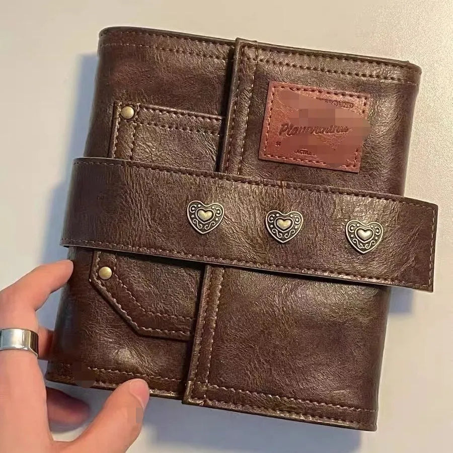Brown retro notebook with buckle closure showing loose-leaf binding and A7 size