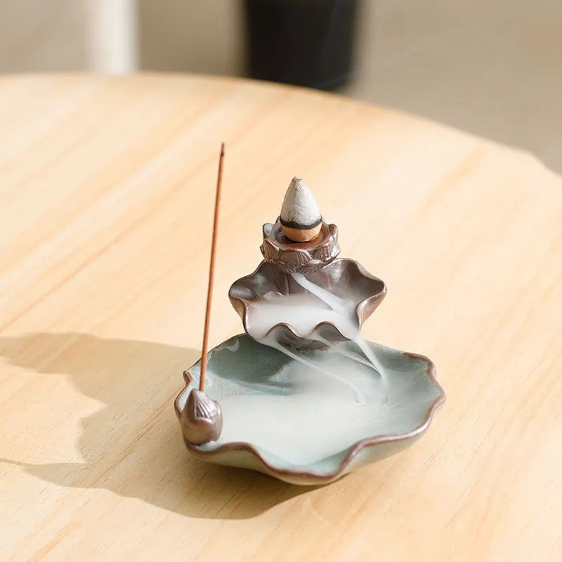 Ceramic reverse flow incense burner in purple clay with crystal glaze featuring lotus or plum blossom design