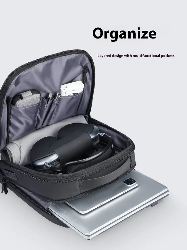 Graphite grey Oxford cloth business backpack with an external USB charging port on the strap.