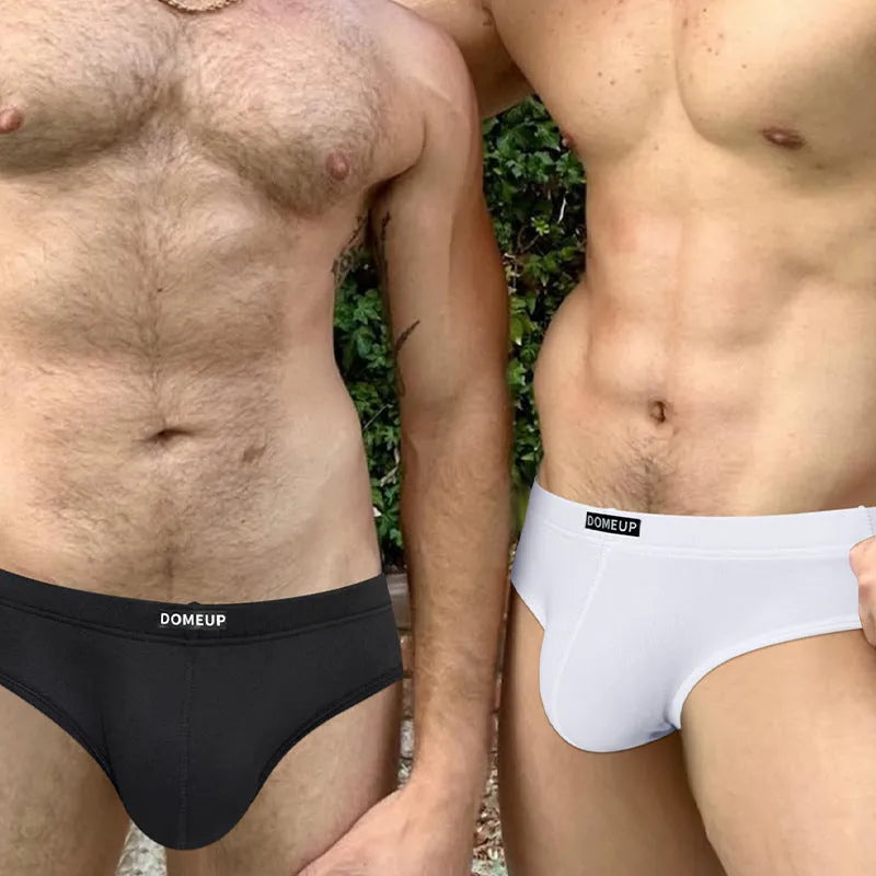 Men's solid colour low waist seamless briefs in black, white, and pink with breathable polyester fabric