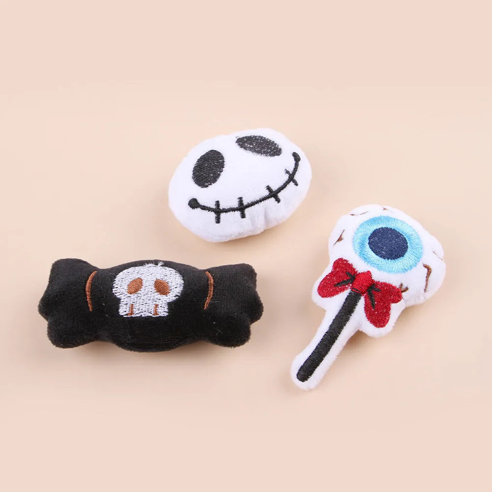 Small plush cat teaser toy with candy, eyes and skull attachments on lightweight handle