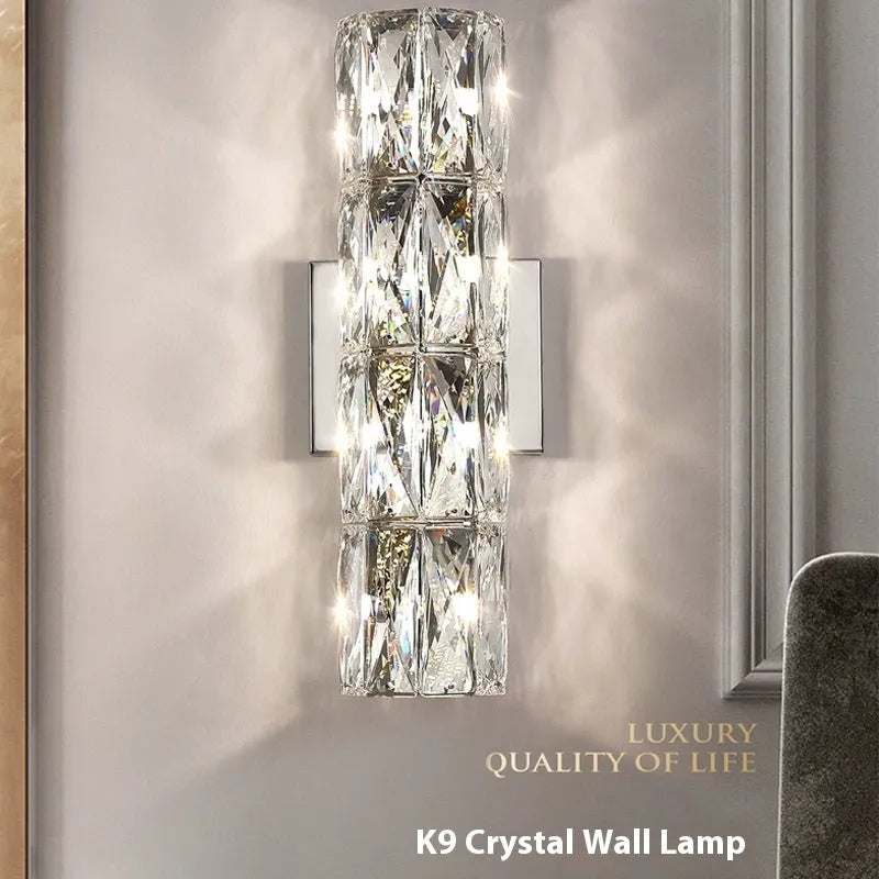Slim crystal and stainless steel wall lamp with LED light on a wall.