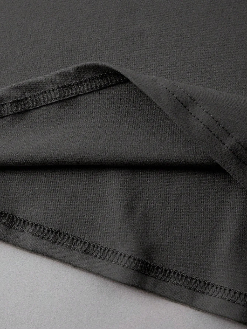 Straight-fit round neck cotton t-shirt in black, green, grey, or orange, shown with short sleeves.