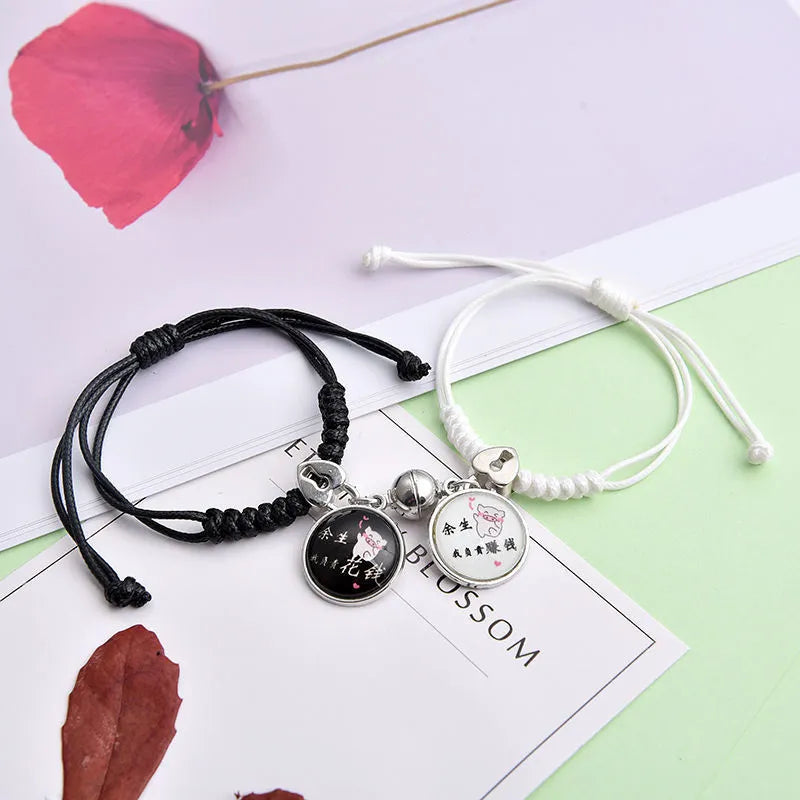 Pair of alloy suction bracelets with engraved symbol choices including crown, love lock, and clover.