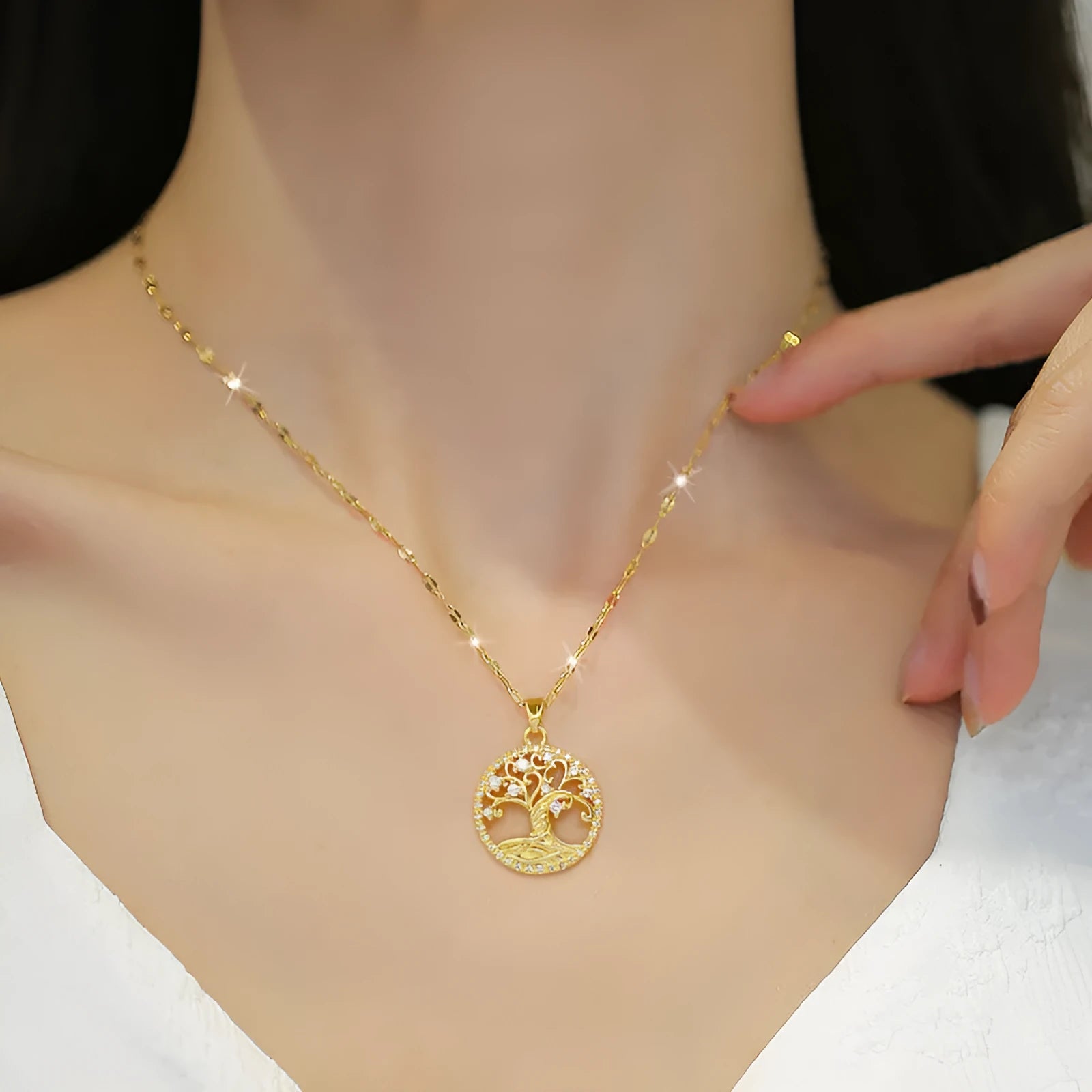 Gold plated Lucky Tree necklace with mother of pearl pendant and rhinestone zircon detail on a lip chain.