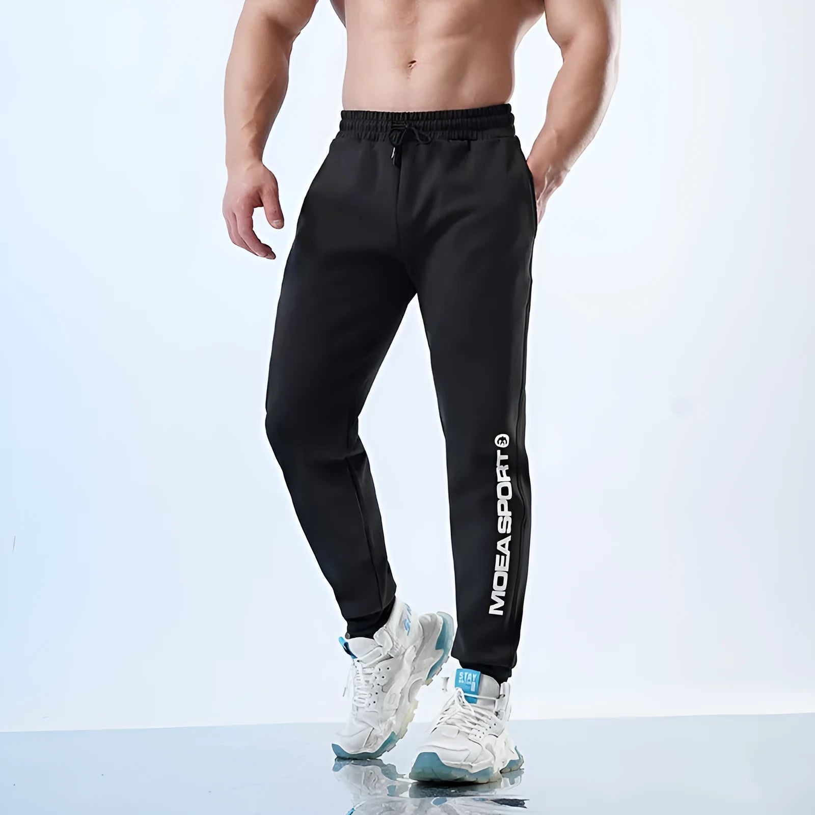 Men's grey sweatpants with ankle ties showing mid-waist design and adjustable calf fit