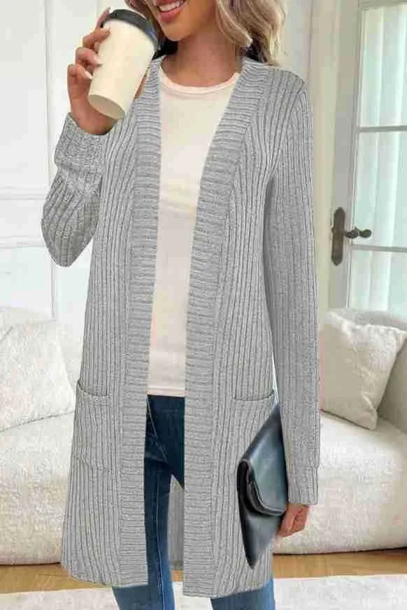 Long sleeve loose fit knitted cardigan jacket in black, shown with two front pockets.