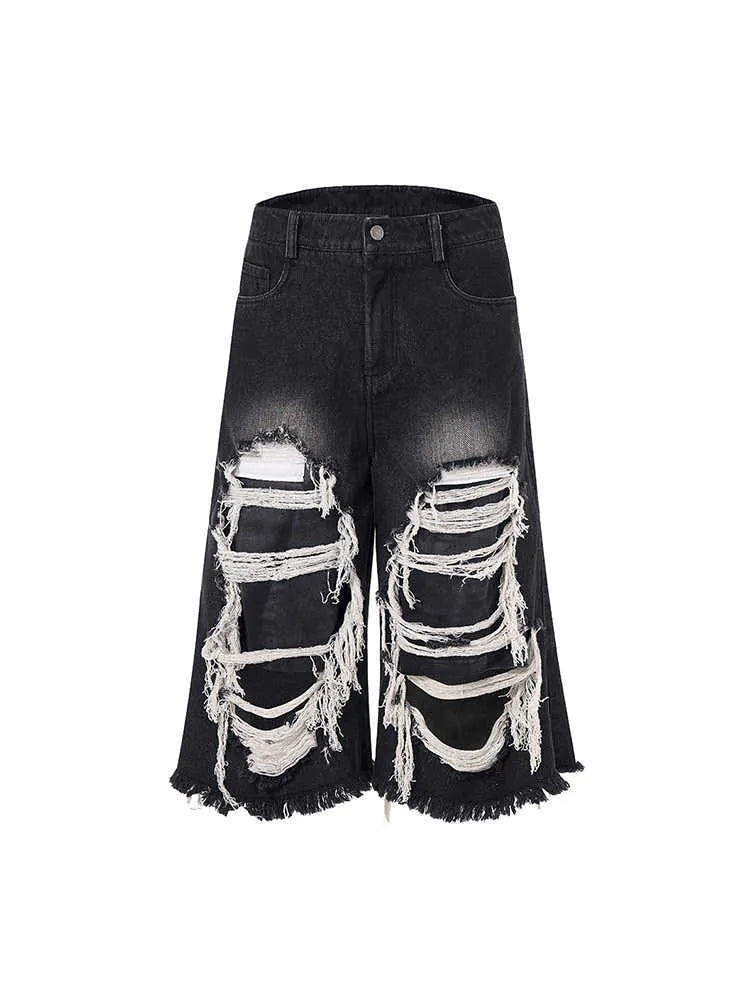 Black women's cropped wide-leg jeans with a mid-high waist and ripped patch distressing.