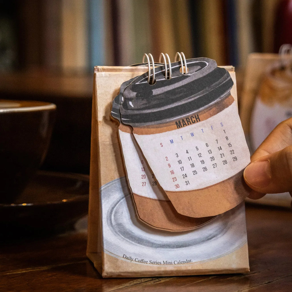 Mini A5 desk calendar 2025 showing one of eight themed designs in simple modern style