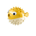 Green fish-shaped dog chew toy with treat dispensing hole and textured surface