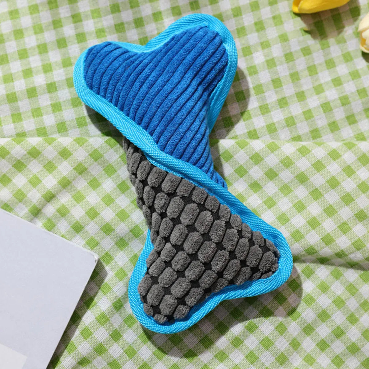 Blue tough plush teddy dog toy with a bone-shaped squeaker and soft corn fleece lining for bite-resistant play.