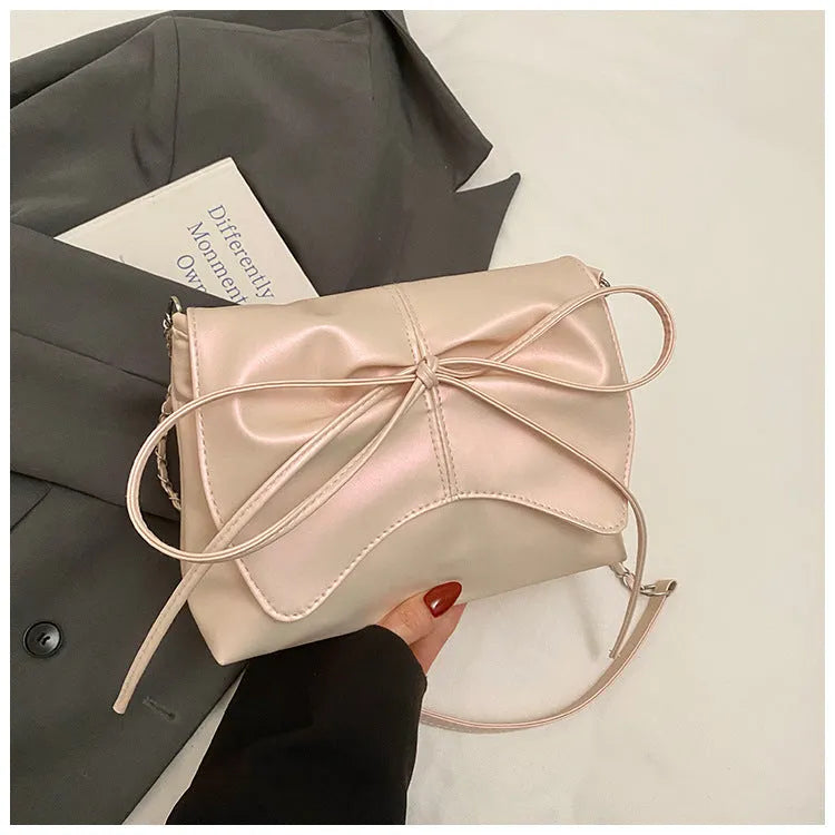 Women's underarm crossbody bag in horizontal square shape with sewing line details and phone pocket