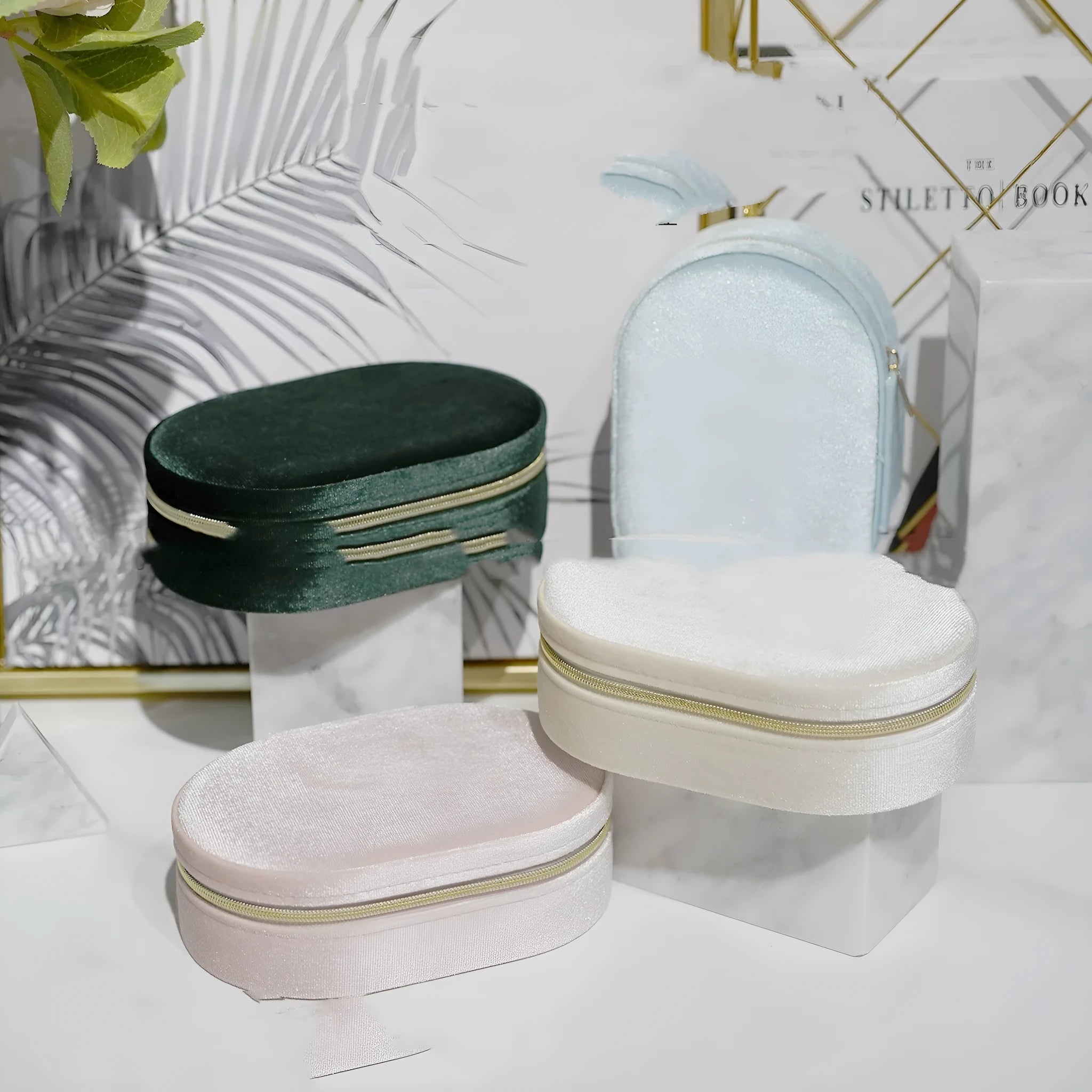 Oval velvet jewellery storage box in lake blue colour showing flannel interior and compact 15x10x5cm dimensions