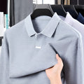 Men's grey asymmetric lapel cotton polo shirt in a loose fit.