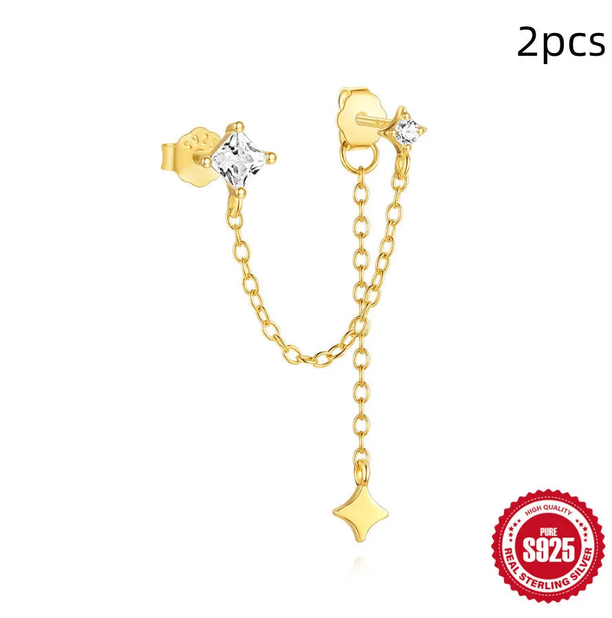 S925 sterling silver stud earrings with zircon inlay in golden geometric designs including clover and crown.