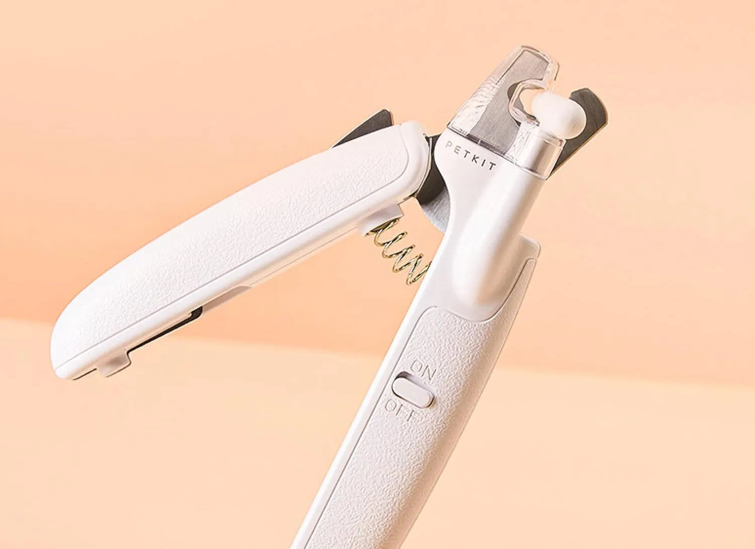White LED pet nail clippers with open anti-splash guard and nail file on a solid colour background