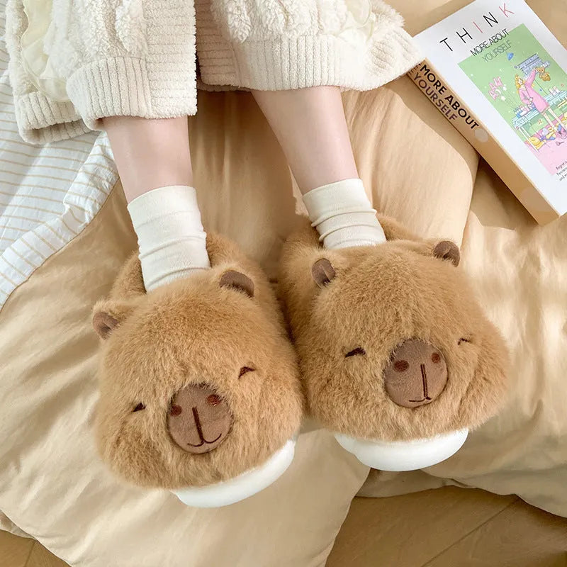 Light brown women's plush winter slippers with a round toe and slip-on design on a white background.