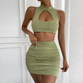Light purple women's hollow vest and matching split skirt two-piece set on a hanger.