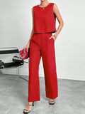 Red two-piece set with sleeveless round neck top and wide-leg trousers laid flat