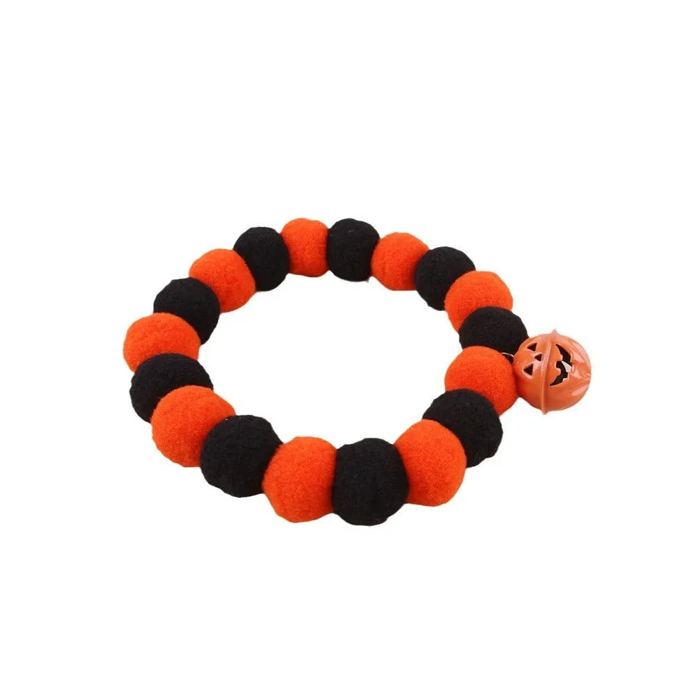 Orange Halloween cat collar with black pumpkin face design and a black adjustable buckle.