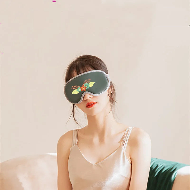 Pink or green portable eye SPA massage goggles on a grey background