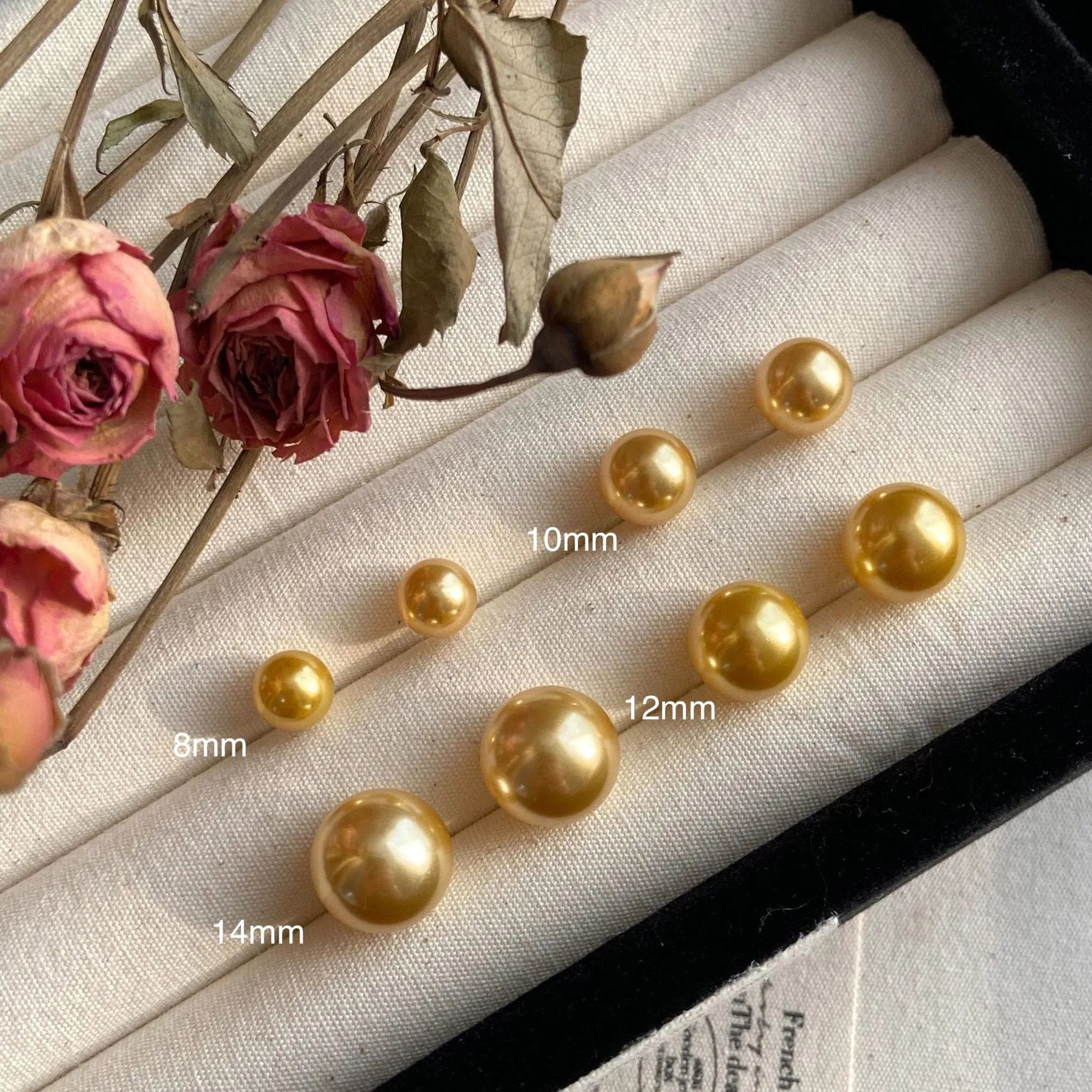 A pair of large geometric pearl stud earrings with an eight-point star detail on silver settings.