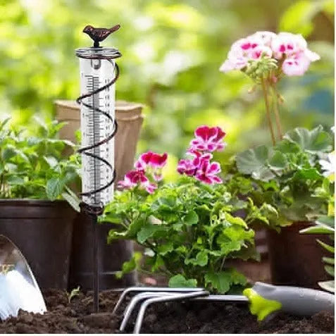 Cast iron bird rain gauge with glass measurement tube showing 1-20 scale for garden rainfall monitoring