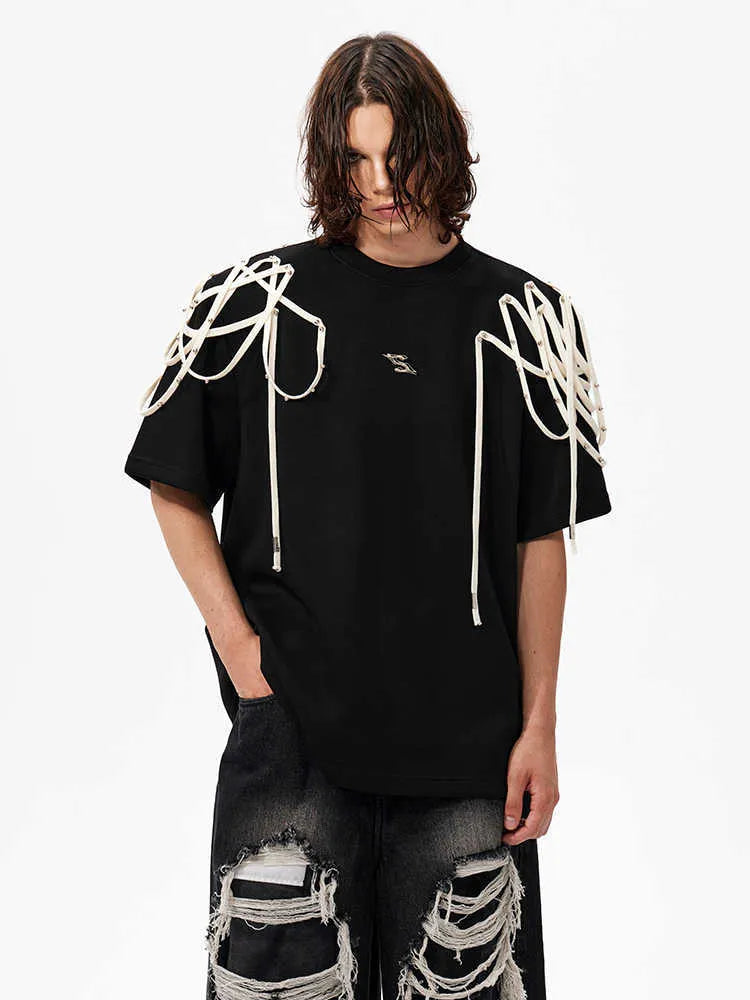 Black loose fit T-shirt with padded shoulders and decorative rivet ribbon detail on a short sleeve.