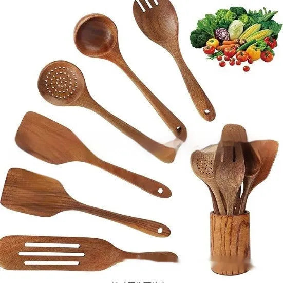 Boxed set of seven wooden kitchen spoons and spatulas on a table.