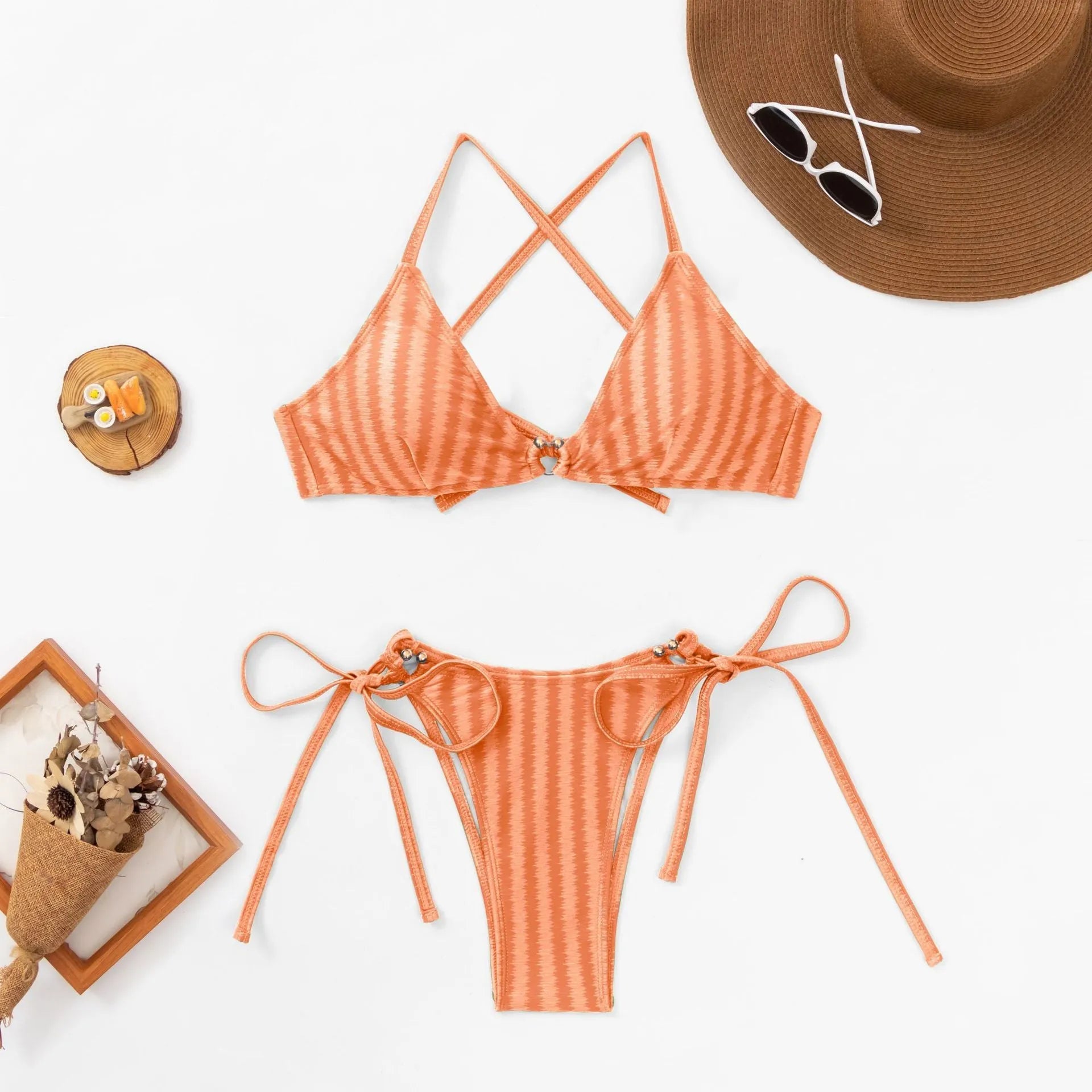 Women's red jacquard lace-up bikini top and matching briefs on a neutral background.