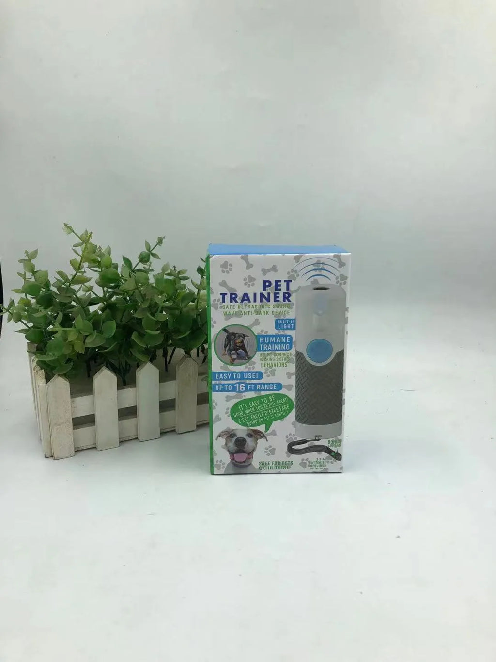 White handheld ultrasonic dog trainer and bark-stop device on a plain background.