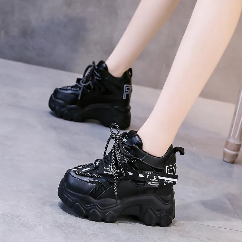 Women's white and black mesh platform sports shoes with cross-strap detail and rubber soles
