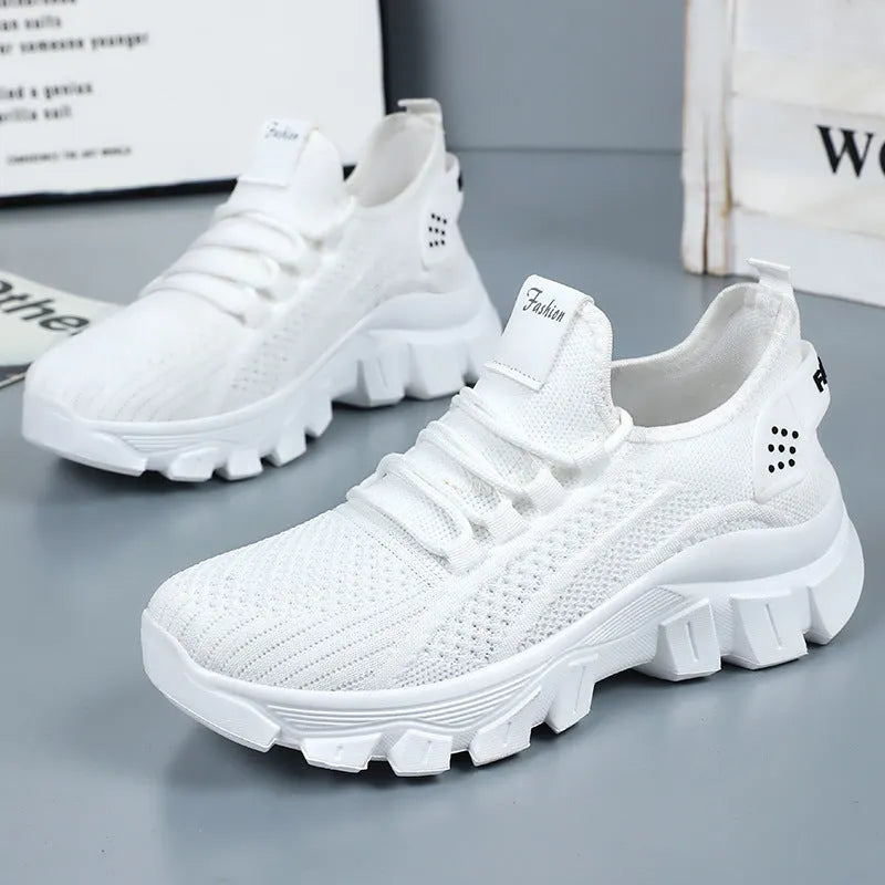 Men's white Flyknit lace-up running sneakers with a thick PVC sole on a plain background.
